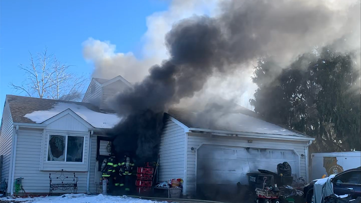 House billowing with thick black smoke