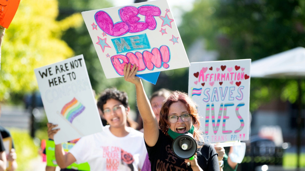 A student leads a group of demonstrators in Knoxville, Tennessee, in protest of the state’s 2022 transgender athlete ban. (Saul Young/Knoxville News-Sentinel /USA Today)  