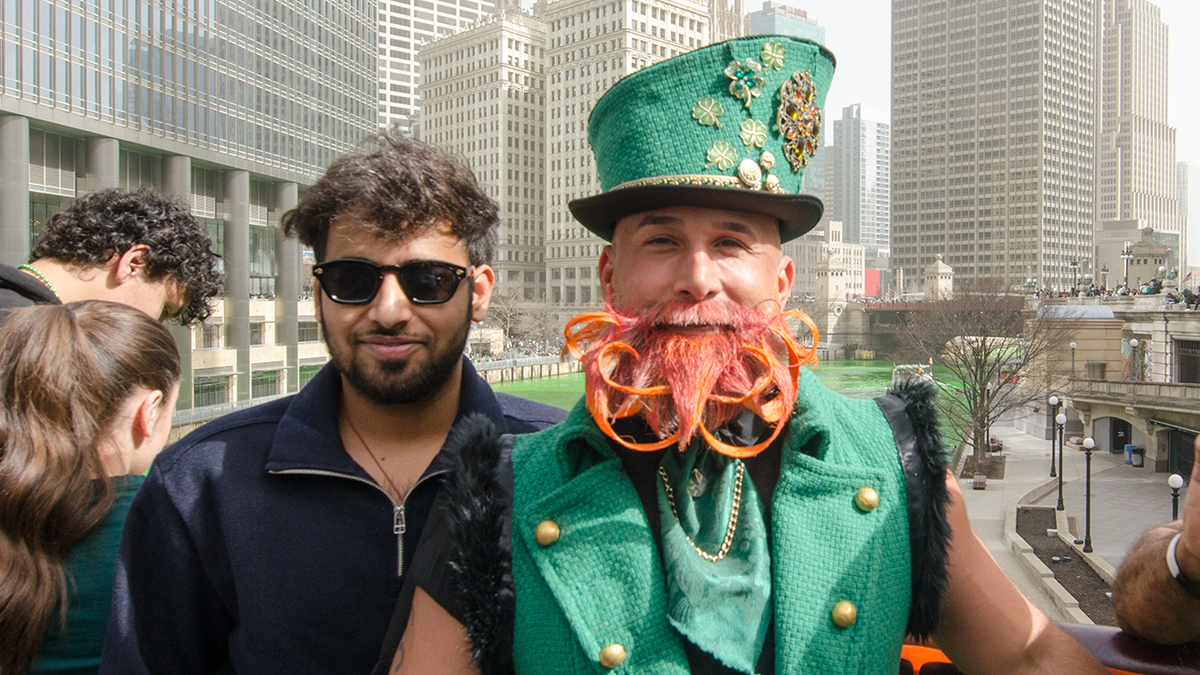 Chicagoans and tourists snap selfies along the Chicago River, now a vibrant green, during St. Patrick's Day celebrations in Chicago.