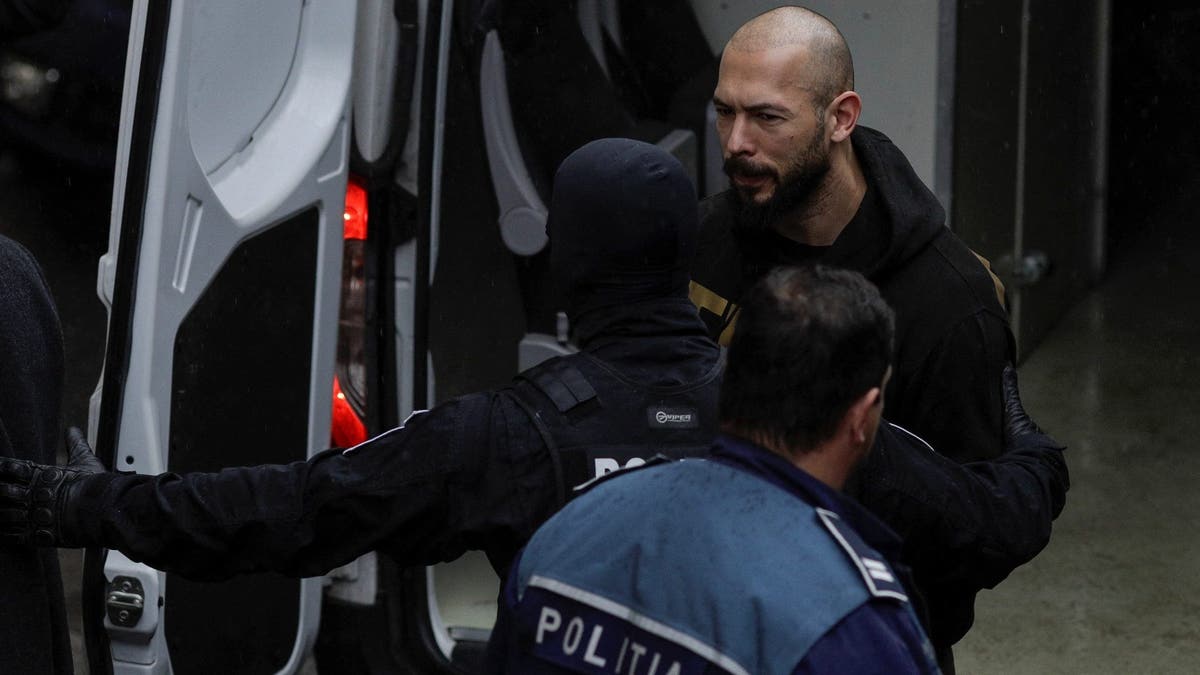 Tate brothers are brought in by police officers at the Bucharest Court of Appeal