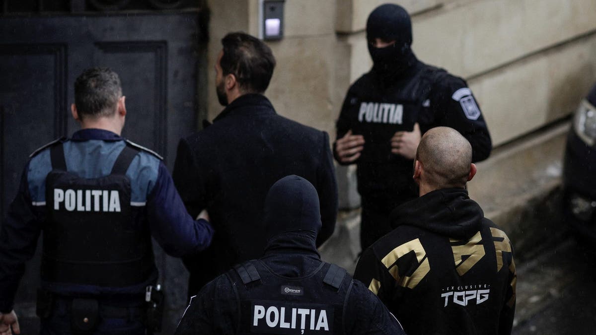 Tate brothers are brought in by police officers at the Bucharest Court of Appeal