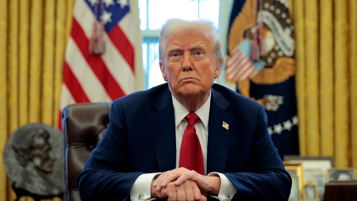 President Trump sits in the Oval Office