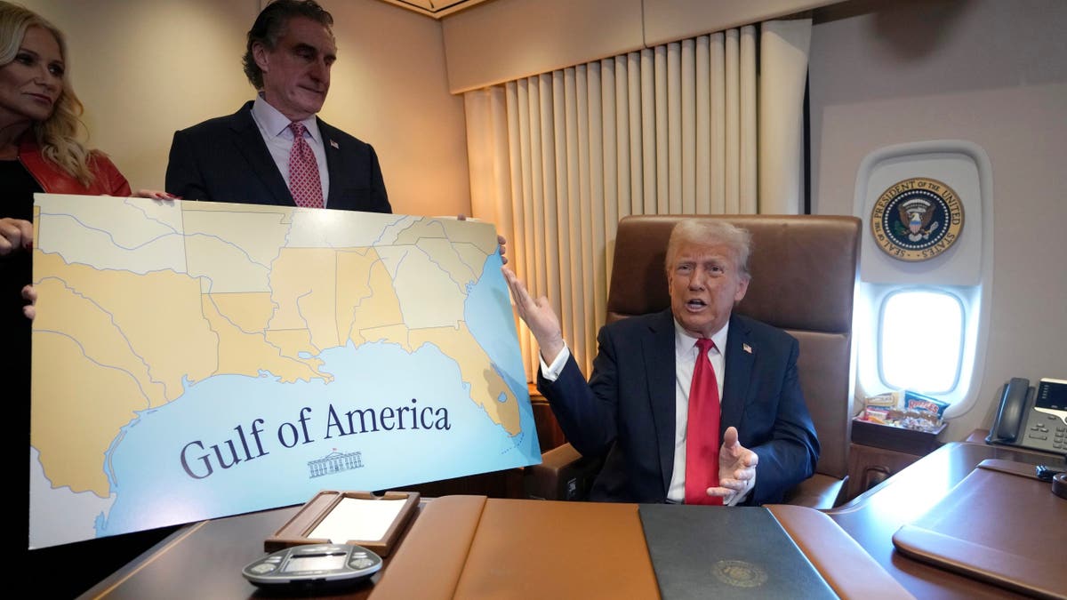 President Donald Trump (right) speaks to reporters accompanied by Interior Secretary Doug Burgum and Burgum's wife Kathryn Burgum, aboard Air Force One where Trump signed a proclamation declaring Feb. 9 Gulf of America Day, as he travels from West Palm Beach, Fla. to New Orleans, Sunday, Feb. 9, 2025.