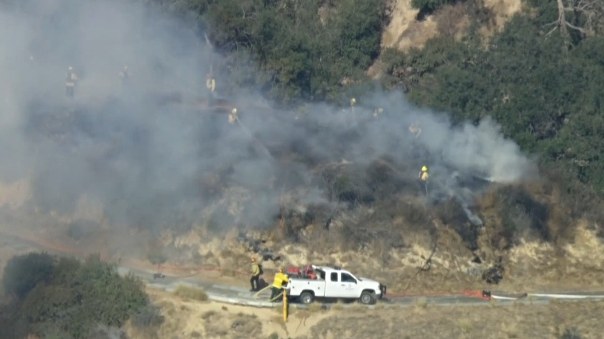 LAFP personnel putting out the Griffith Park brush fire on Monday