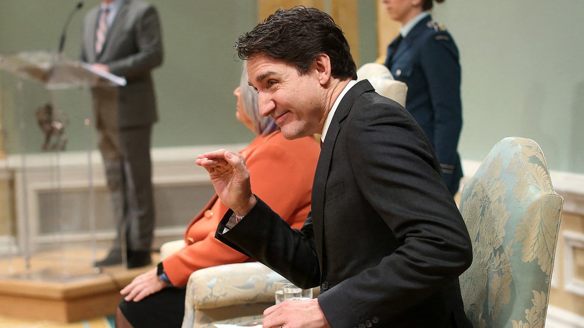 Justin Trudeau with his hand in the air