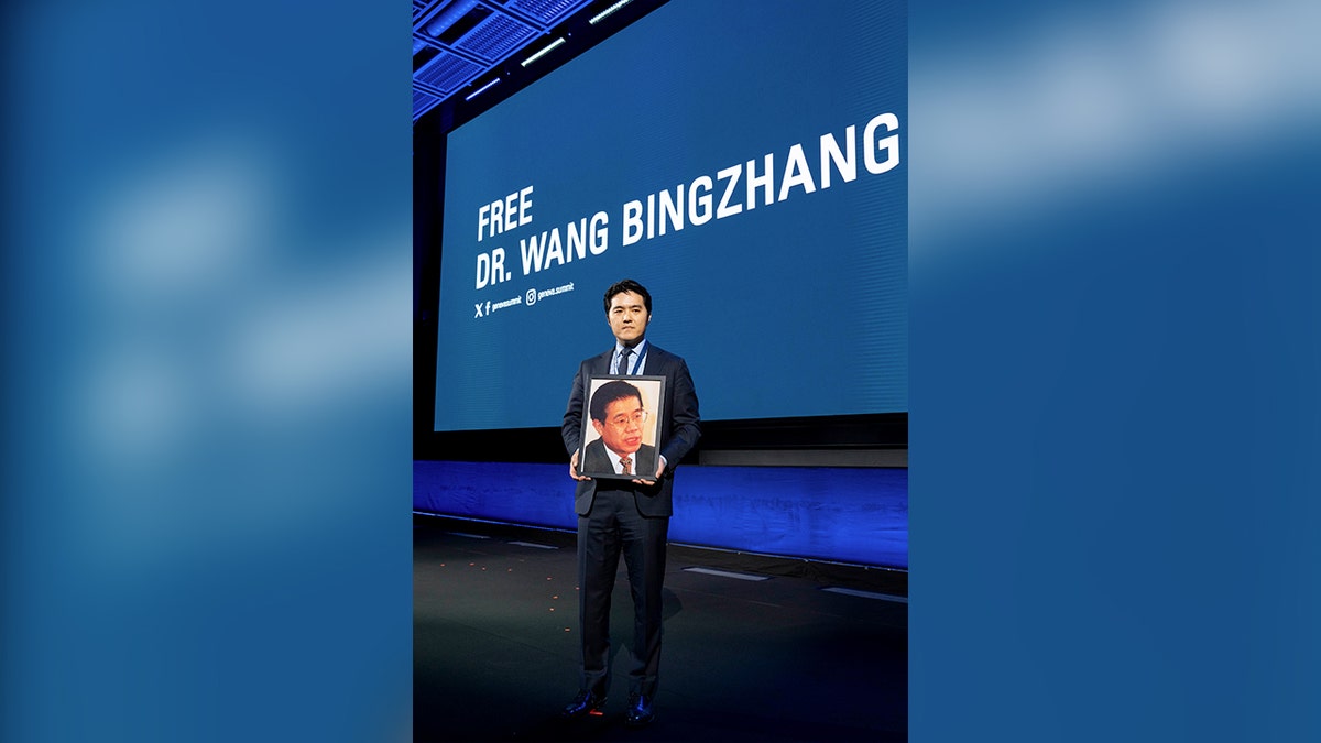 Times Wang holds an image of his father, Chinese prisoner Dr. Wang Bingzhang