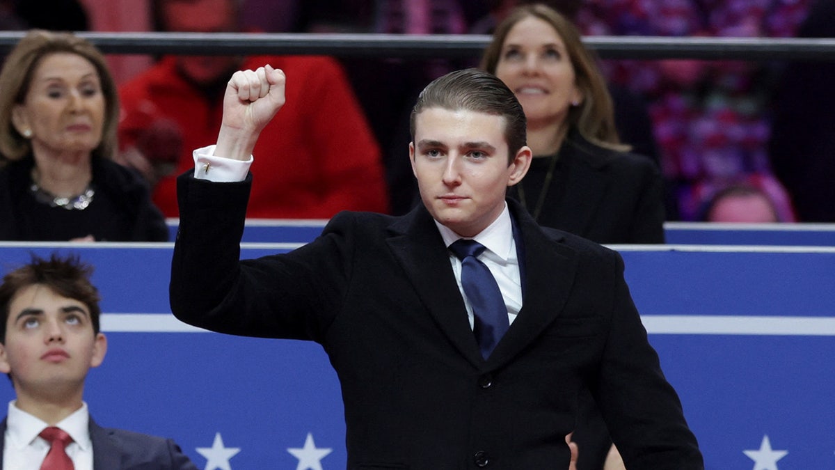 Barron Trump gestures at President Donald Trump's rally after the Inauguration