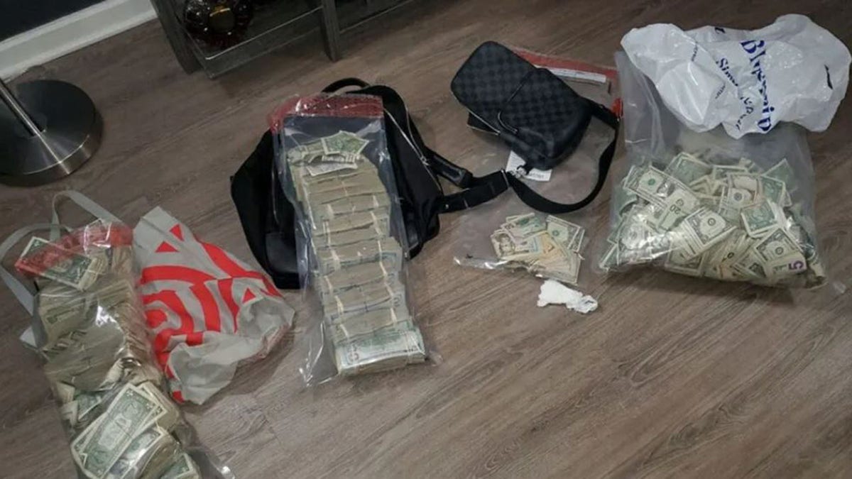 A stack of money and drugs found by the NYPD during a raid