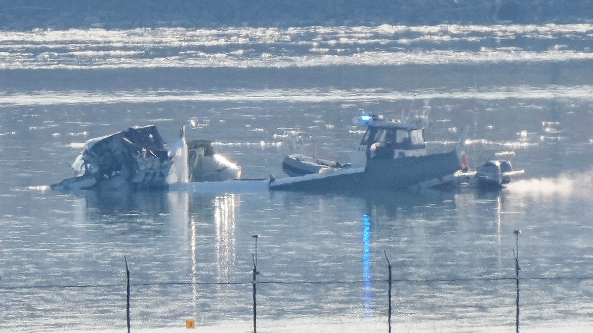 Search and rescue efforts are seen around a wreckage site in the Potomac River