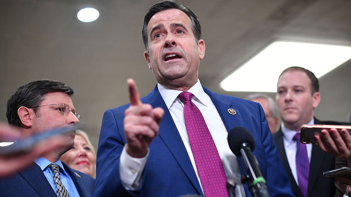 John Ratcliffe talking to reporters