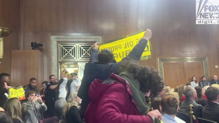 More protestors interrupt and are escorted out of Chris Wright's confirmation hearing.