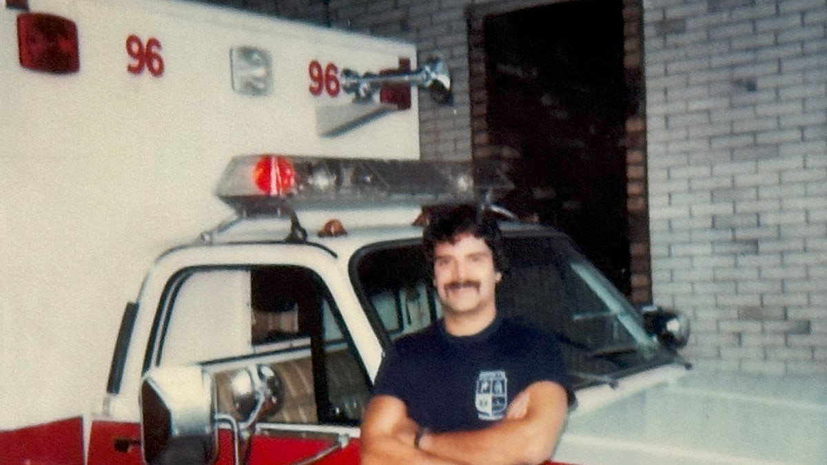 Ken Tekiela smiling and posing in front of a truck.