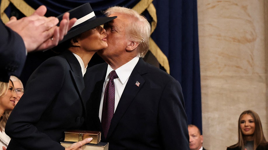 U.S. President-elect Donald Trump greets Melania Trump as he arrives for inauguration ceremonies