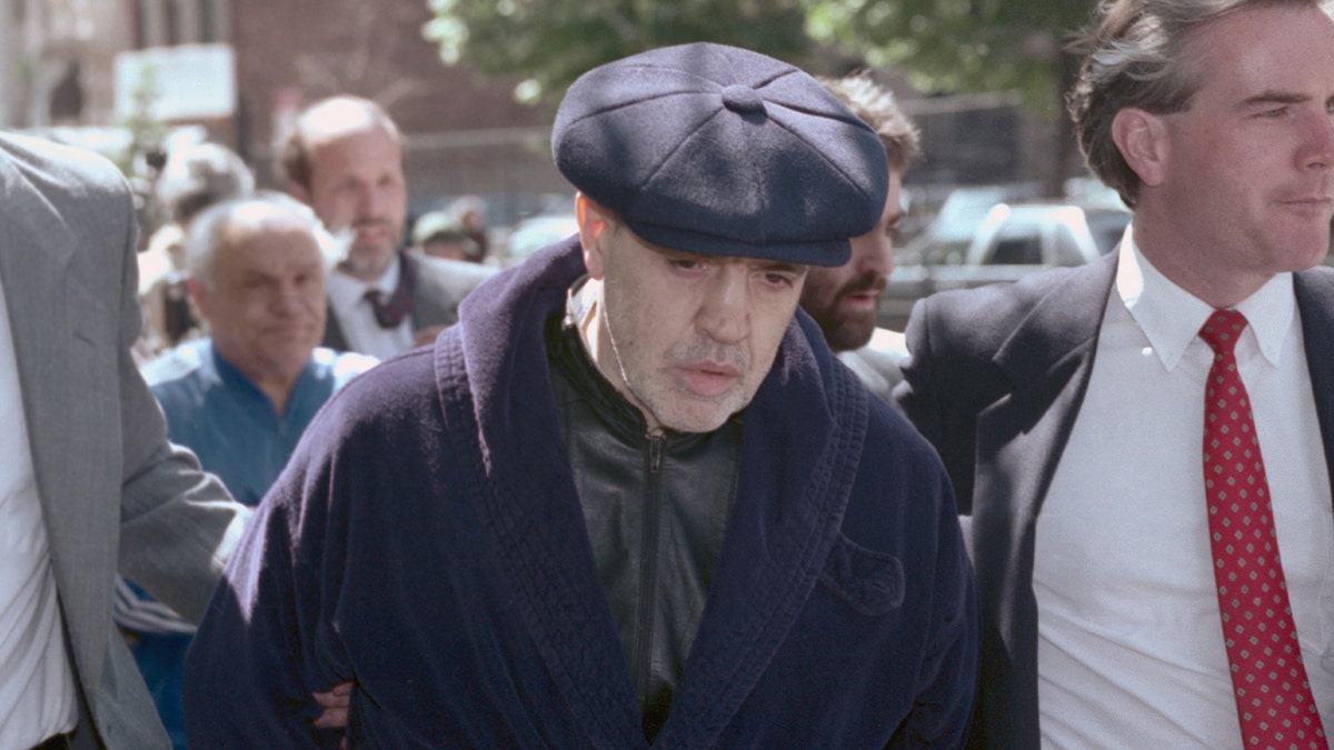 Vincent Gigante, the head of the Genovese family, escorted in handcuffs