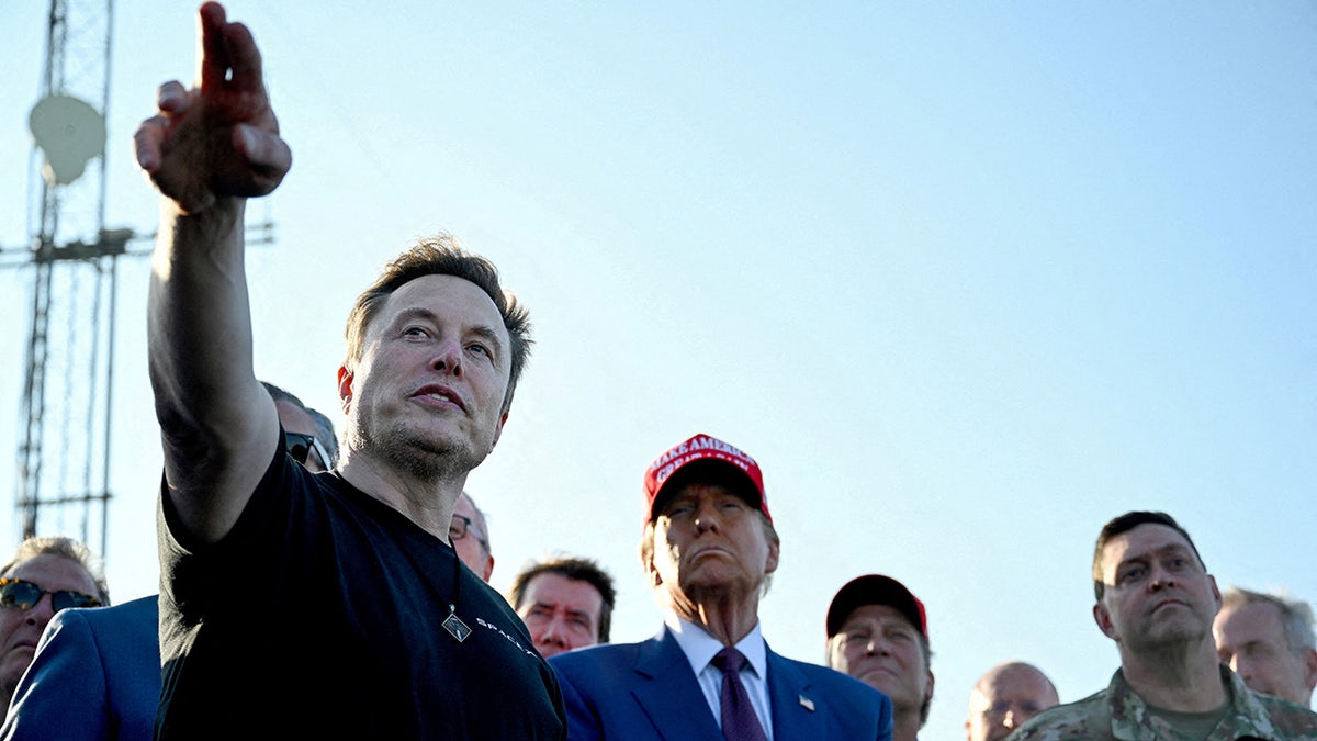 Elon Musk, left, pointing, with Donald Trump at right