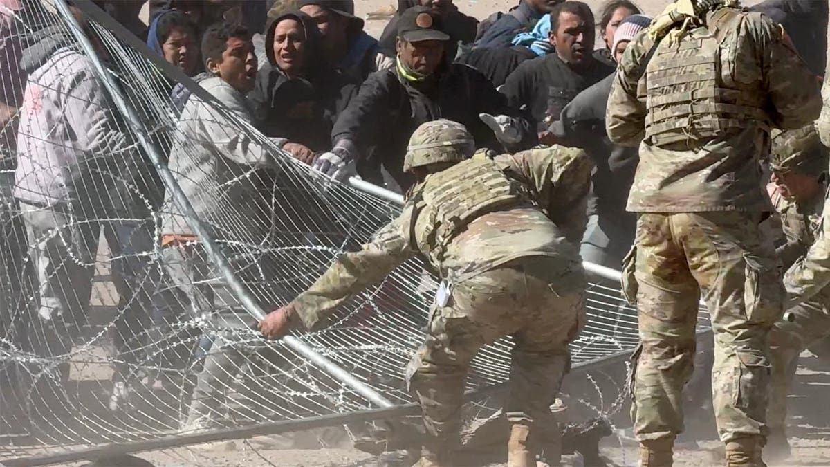 Migrants storm border gate in El Paso