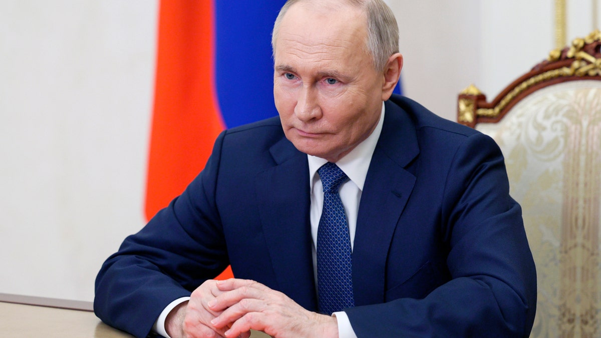 Vladimir Putin closeup shot, Russia flag behind him