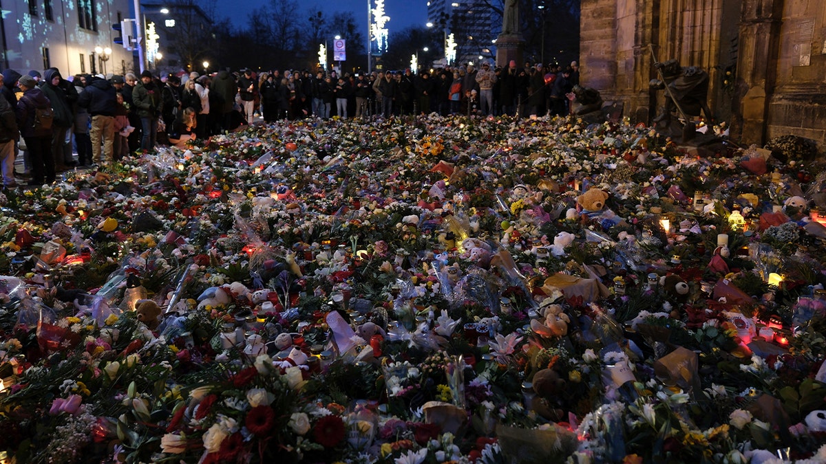 Mourners place items near German Christmas market following attack