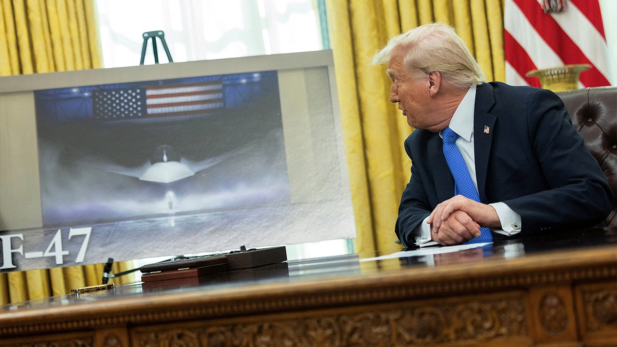 President Trump looks at a poster of the F-47 fighter jet