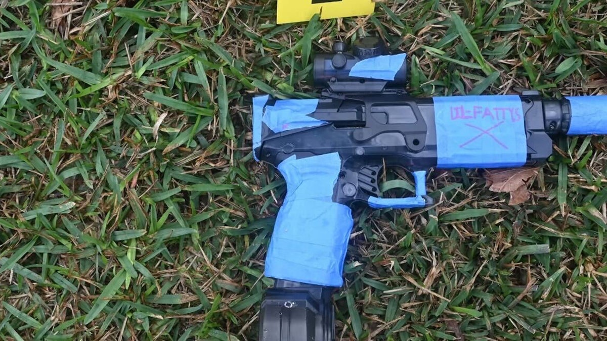 The toy water gun carried by the 18-year-old student is marked as evidence.