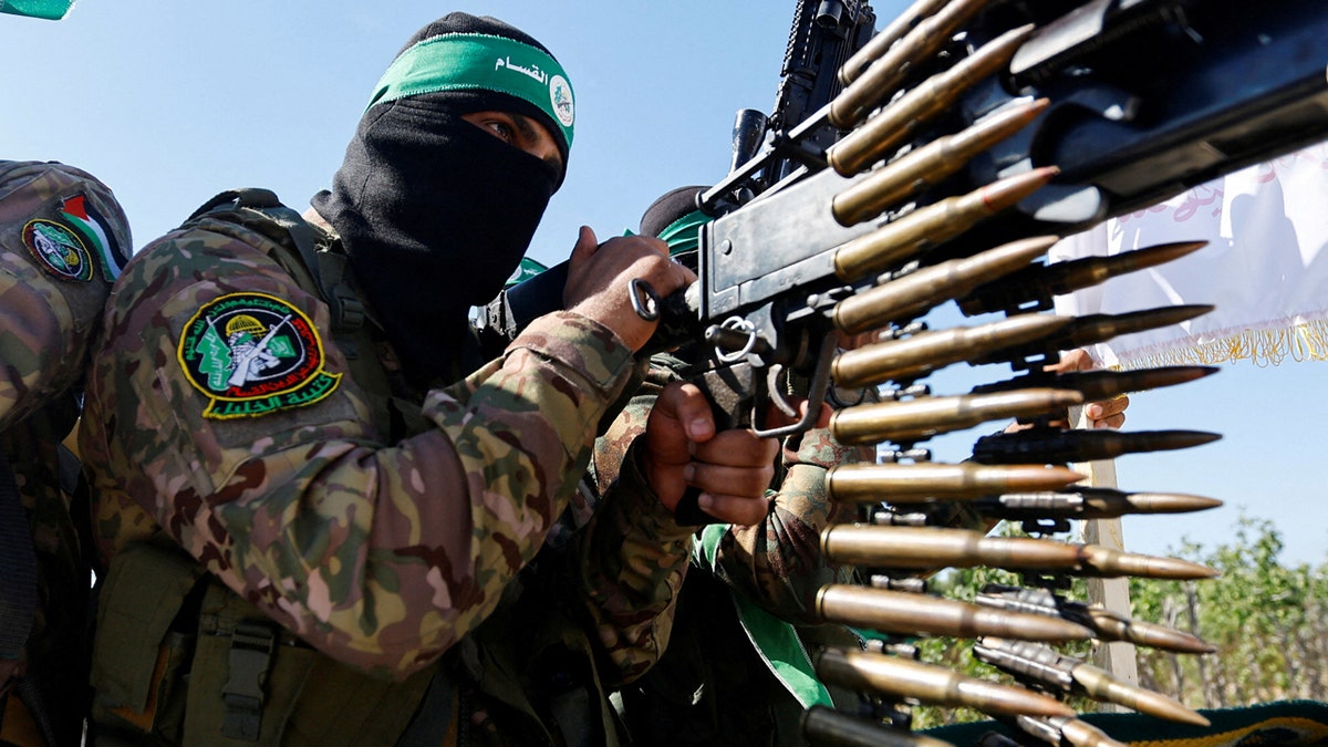 A Palestinian fighter from the armed wing of Hamas takes part in a military parade