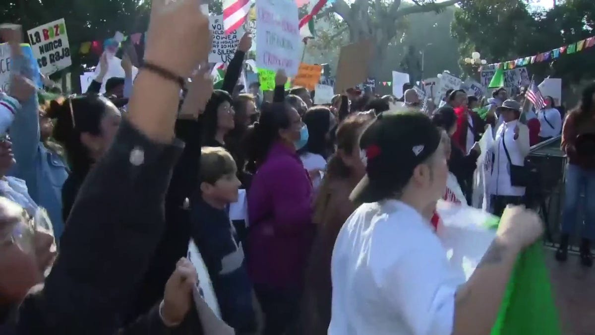 Protesters carry anti-ICE signs in downtown Los Angeles