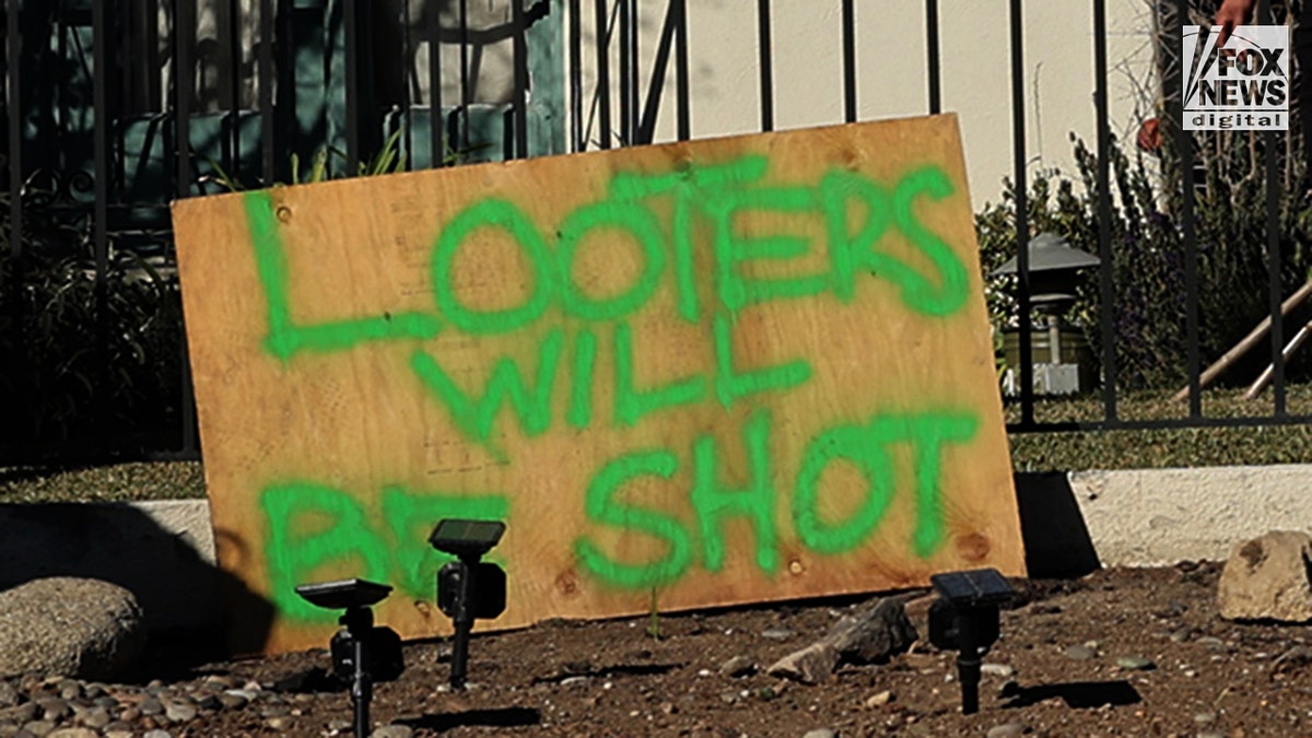 A sign in front of a home in the California fires says looters will be shot