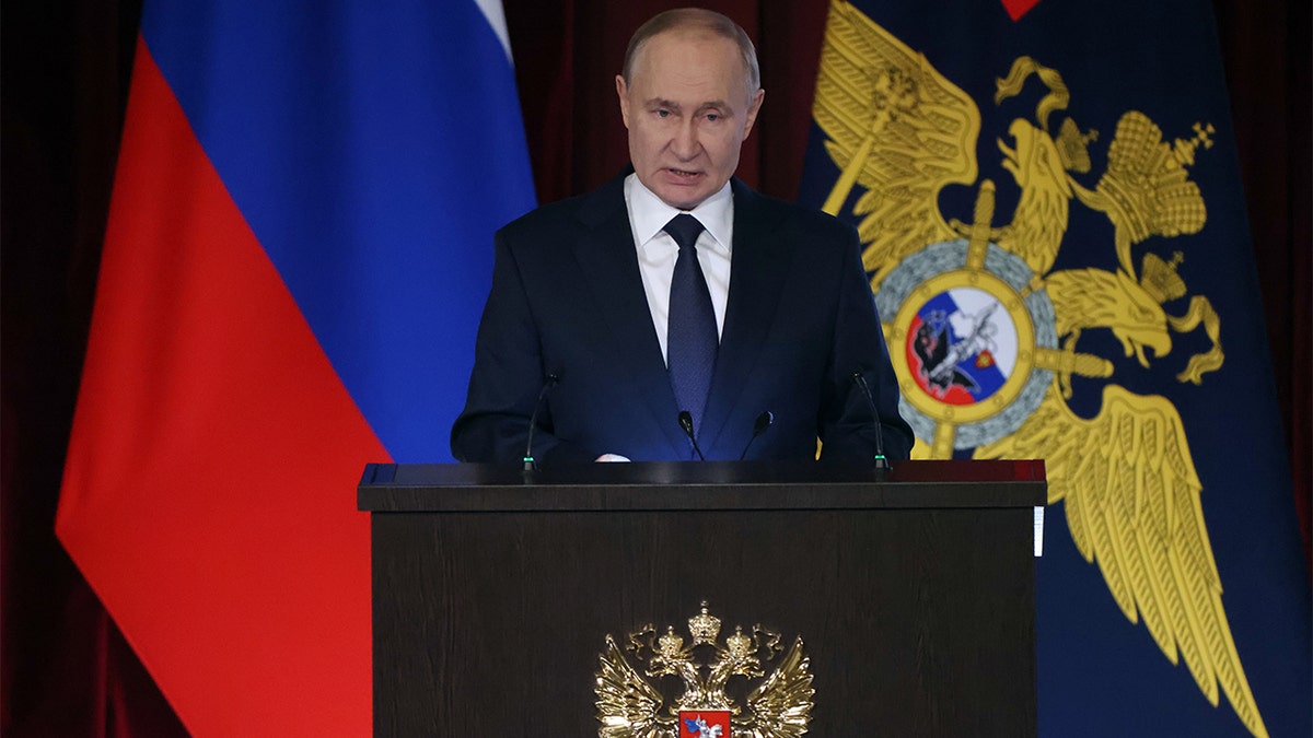 Putin speaking at the podium.