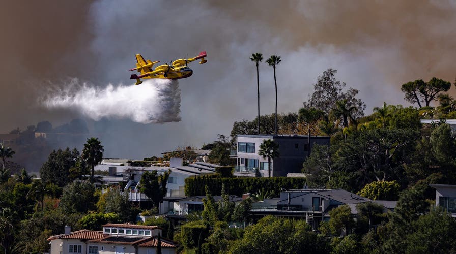 Firefighter plane scoops ocean water to battle Southern California wildfires