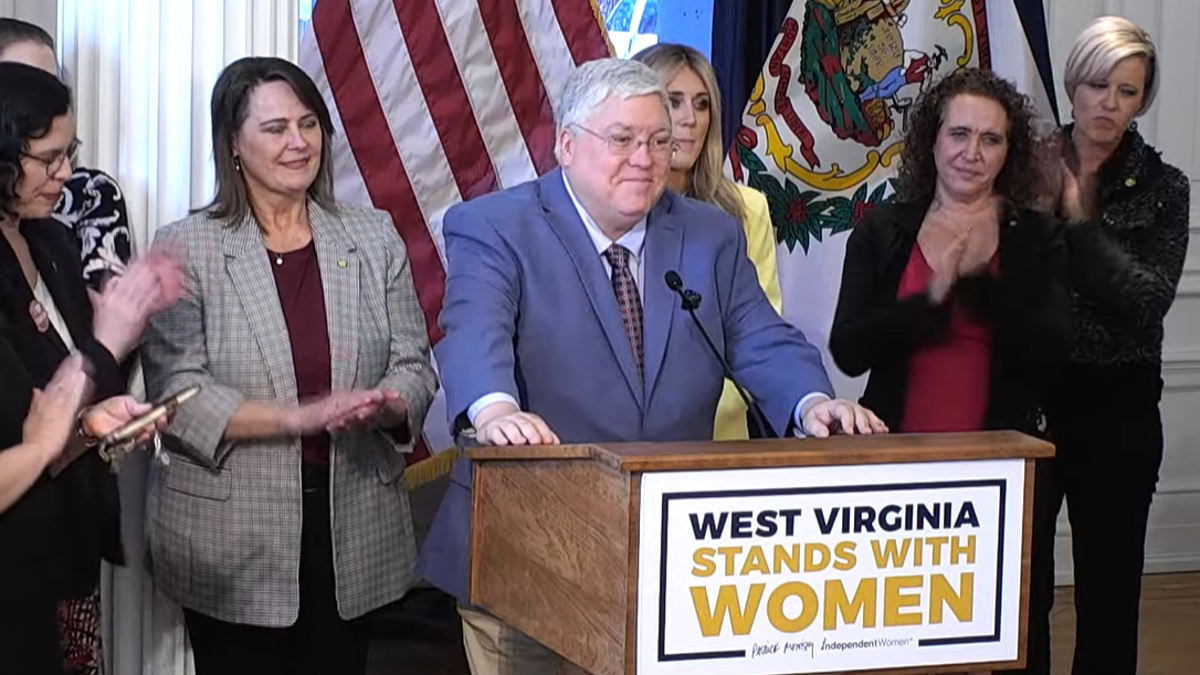 Gov. Patrick Morrisey, Riley Gaines, IWF's Heather Higgins (r.), and Sen. Patricia Rucker, R-Charles Town, (l.) are seen at a bill-signing event.