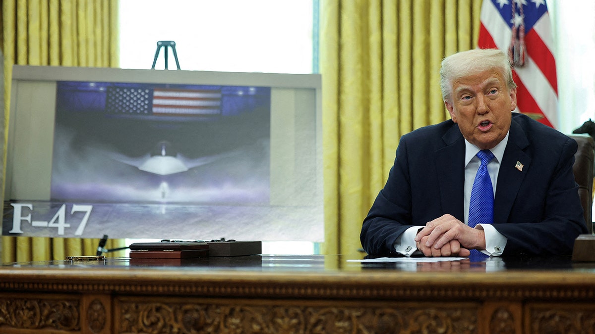 President Donald Trump alongside an image of an F-47 fighter jet to be built by Boeing