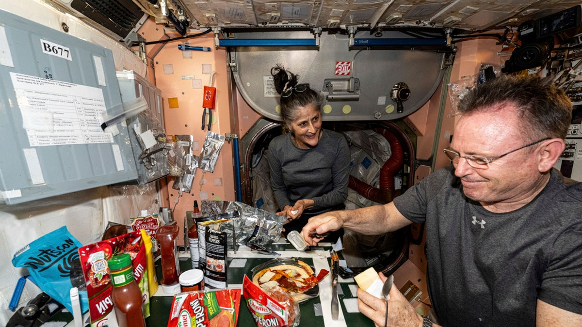 Wimore and Williams eating at the ISS