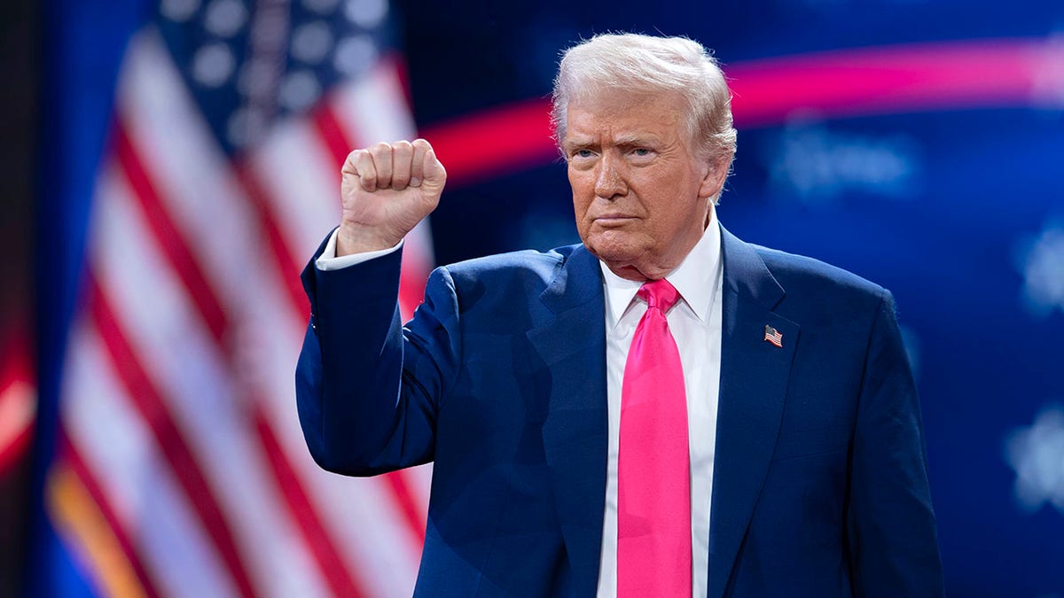 President Donald Trump gestures to the crowd at the Conservative Political Action Conference at the Gaylord National Resort.