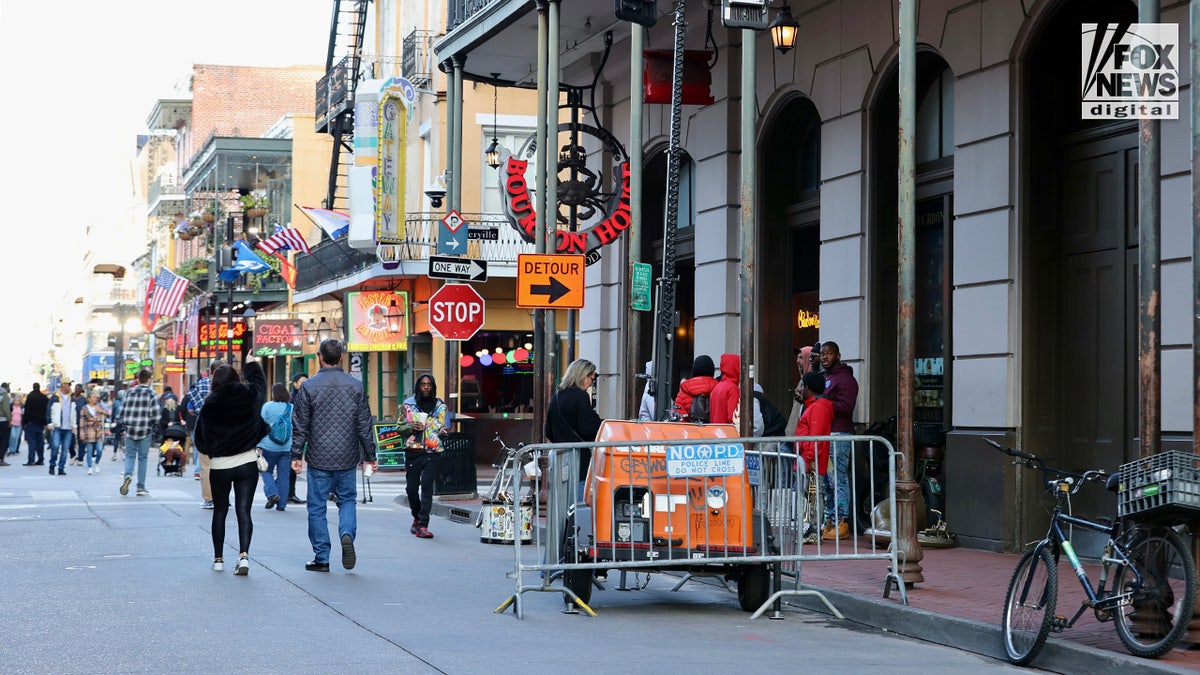 Pedestrians walk down Bourbon Street as it is reopened in New Orleans, Louisiana