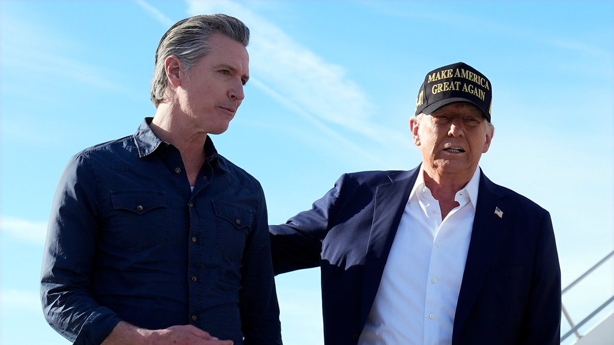 Trump, right, with arm on Gov. Newsom's back