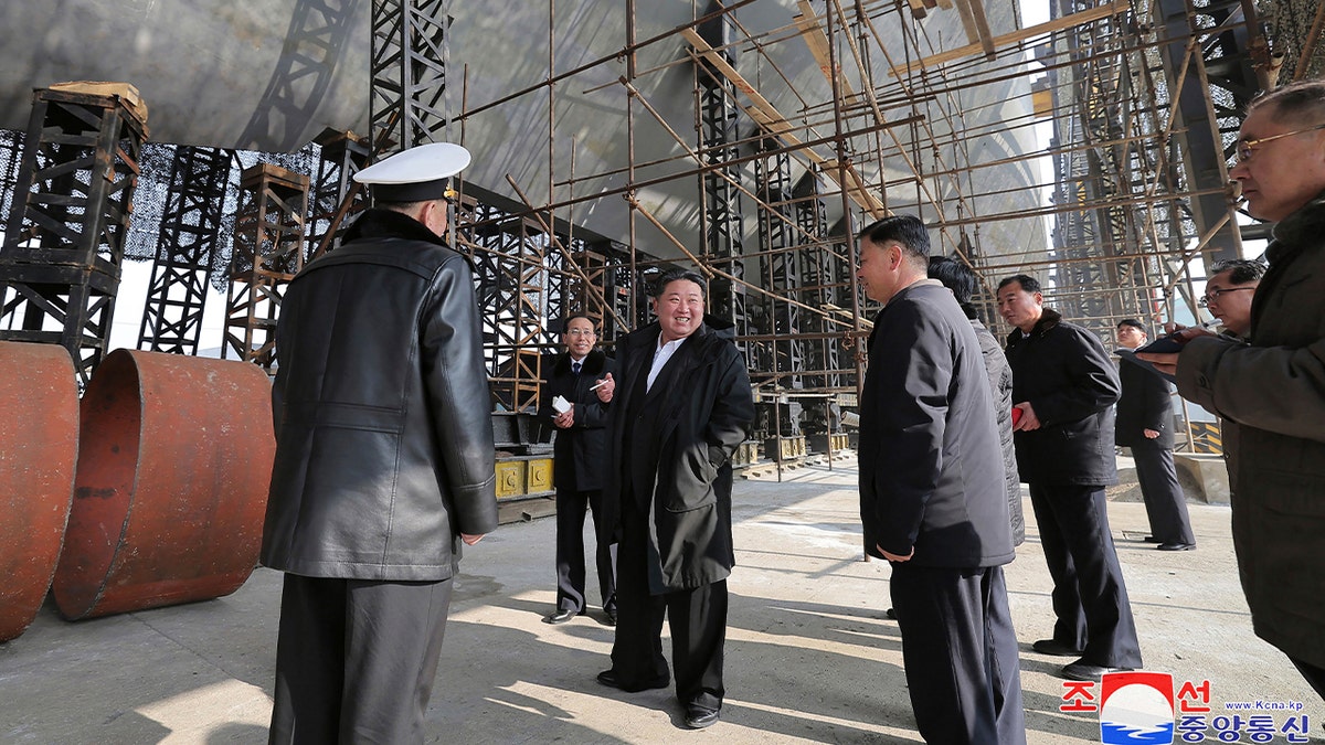 North Korean leader Kim Jong Un, center, visits a shipyard