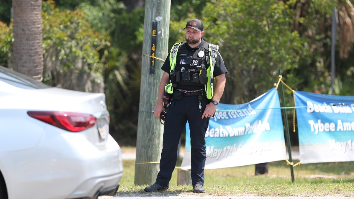 A K-9 officer stands on the shoulder as law enforcement officers from multiple agencies conduct traffic safety checks in conjunction with the Governor's Office of Highway Safety on Friday, April 19, 2024 on Tybee Island.