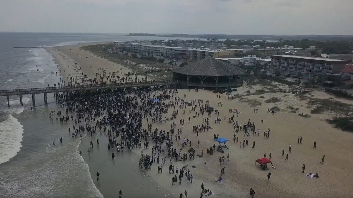 Aerial drone footage showing a packed beach of Tybee Island, Georgia, which has a population of 3,000.