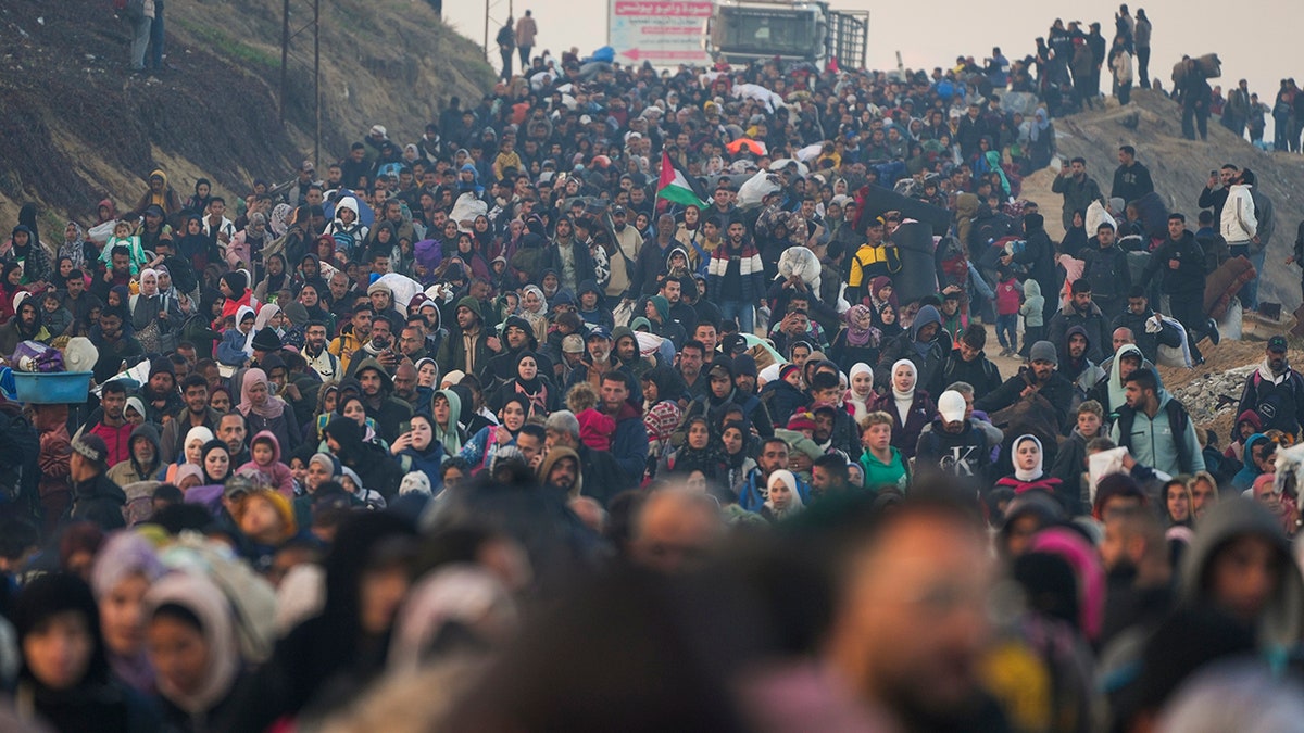 Palestinians walk on road to northern Gaza