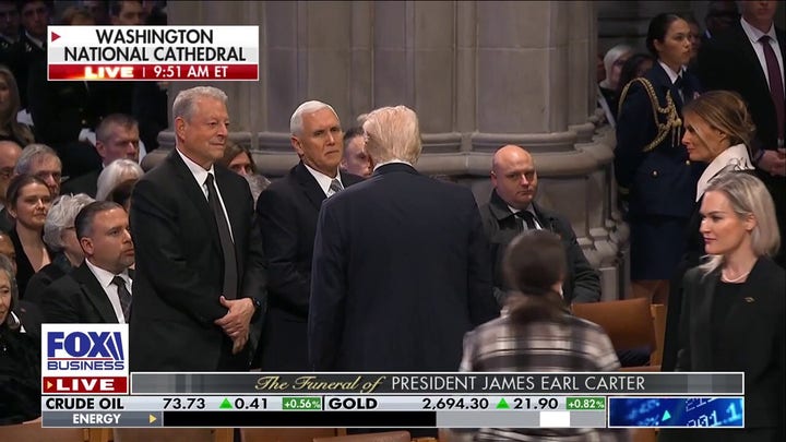 Trump and Pence shake hands at former President Carter's funeral