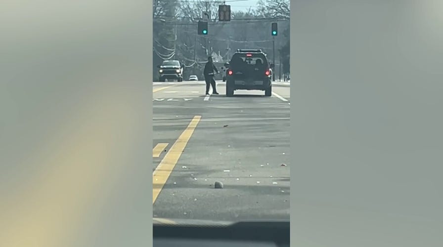 Suspect swings ax at car in apparent road rage incident