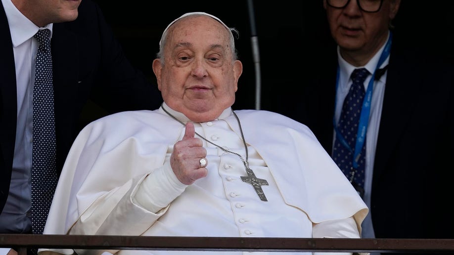 Pope Francis gives the crowd a thumbs up