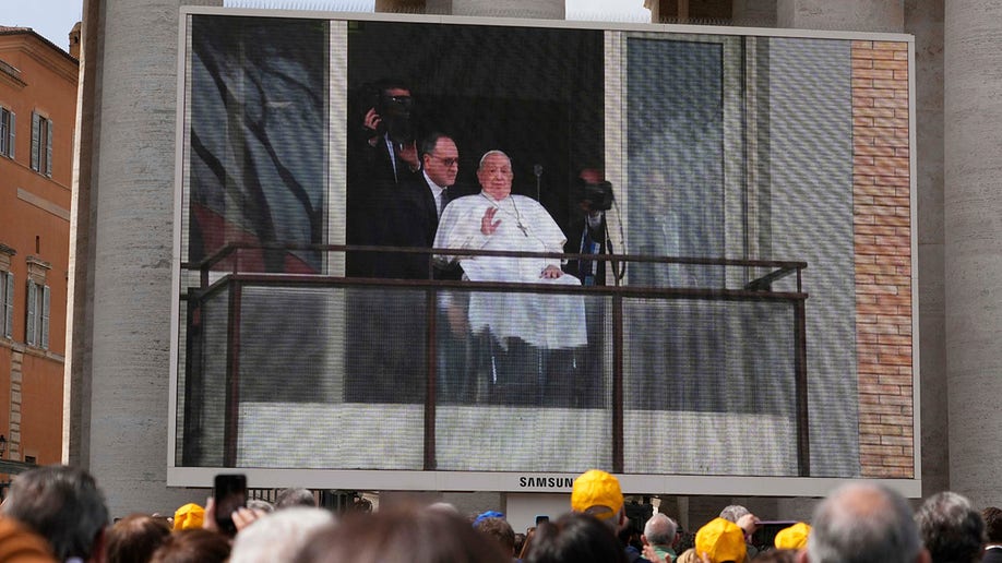 Pope Francis in a wheelchair by hospital window