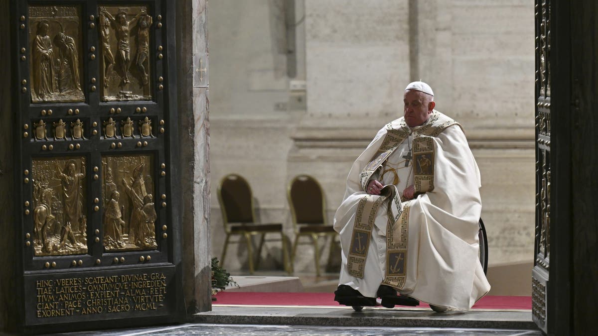 Pope Francis opens the Holy Door of St Peter's Basilica to mark the start of the Catholic Jubilee Year, at the Vatican, Dec. 24, 2024.