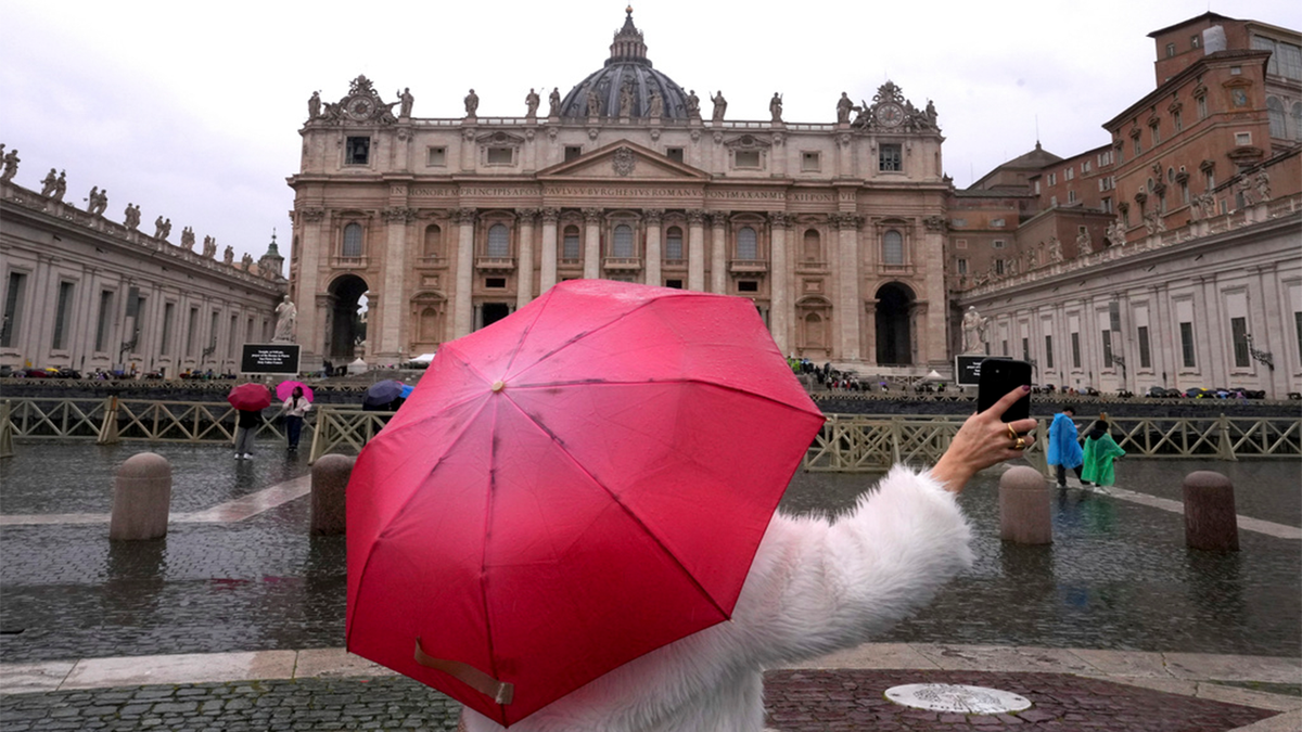 Woman takes picture outside Vatican