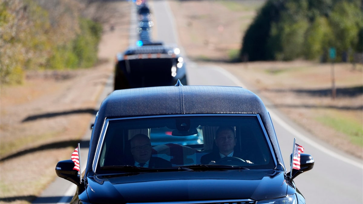 presidential funeral hearse and motorcade seen looking back