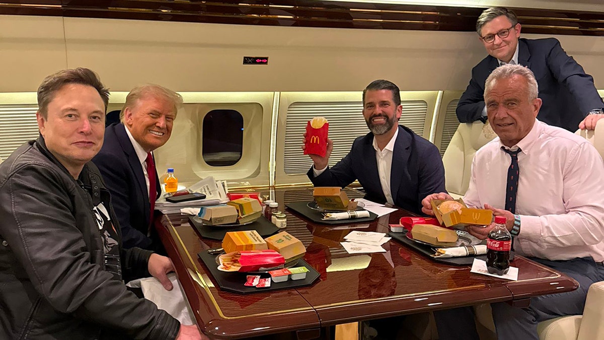 Trump on plane with RFK Jr, Elon Musk, others with McDonald's food on table