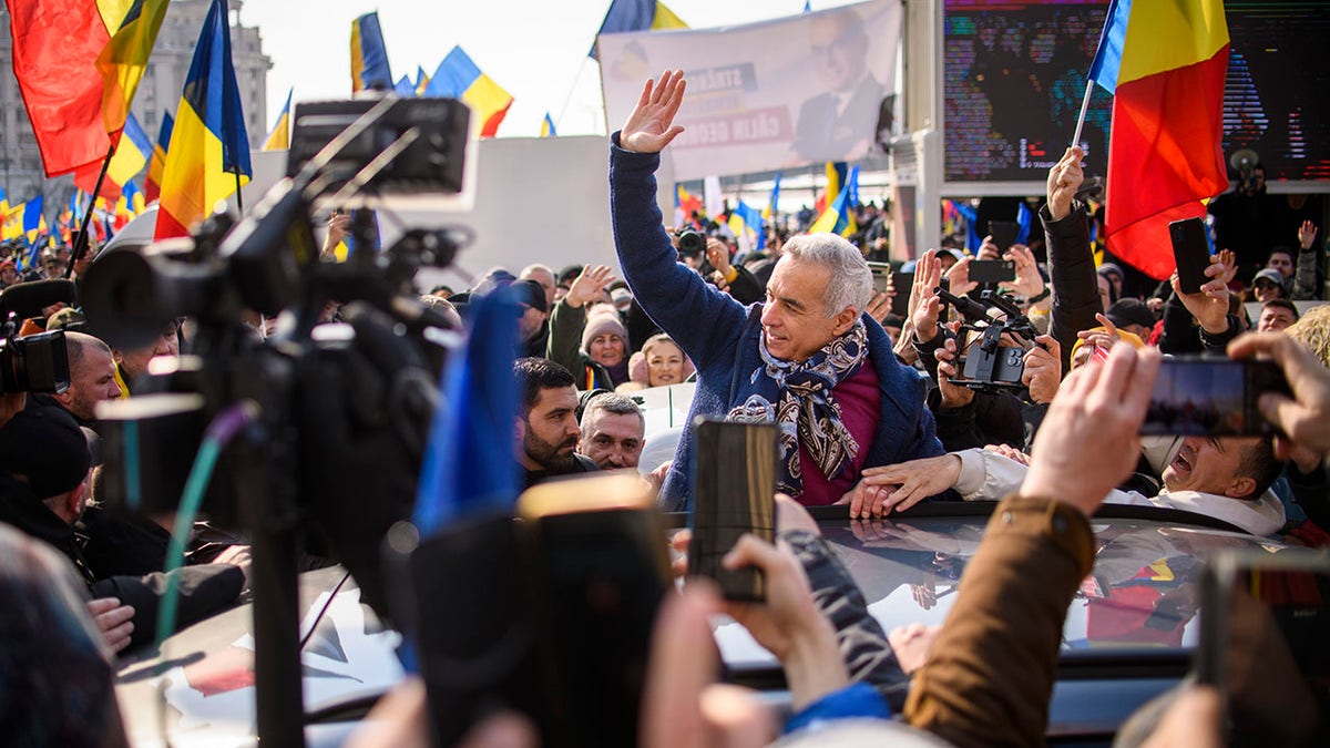 Georgescu waves to supporters