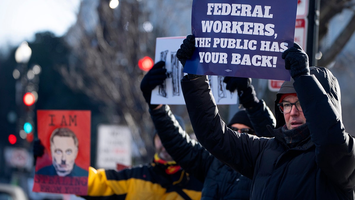 Demonstrators rally in support of federal workers outside of the Department of Health and Human Services, Friday, Feb. 14, in Washington. 