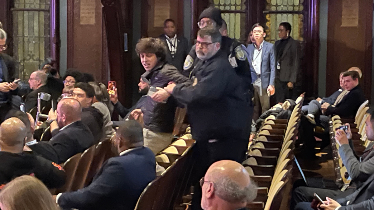 Hecklers are seen being removed by Georgetown University security at the DNC chair election debate at Georgetown University on Jan. 30 2025.